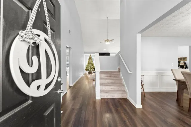 a view of a hallway with wooden floor and entryway