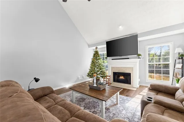 a living room with furniture a flat screen tv and a fireplace