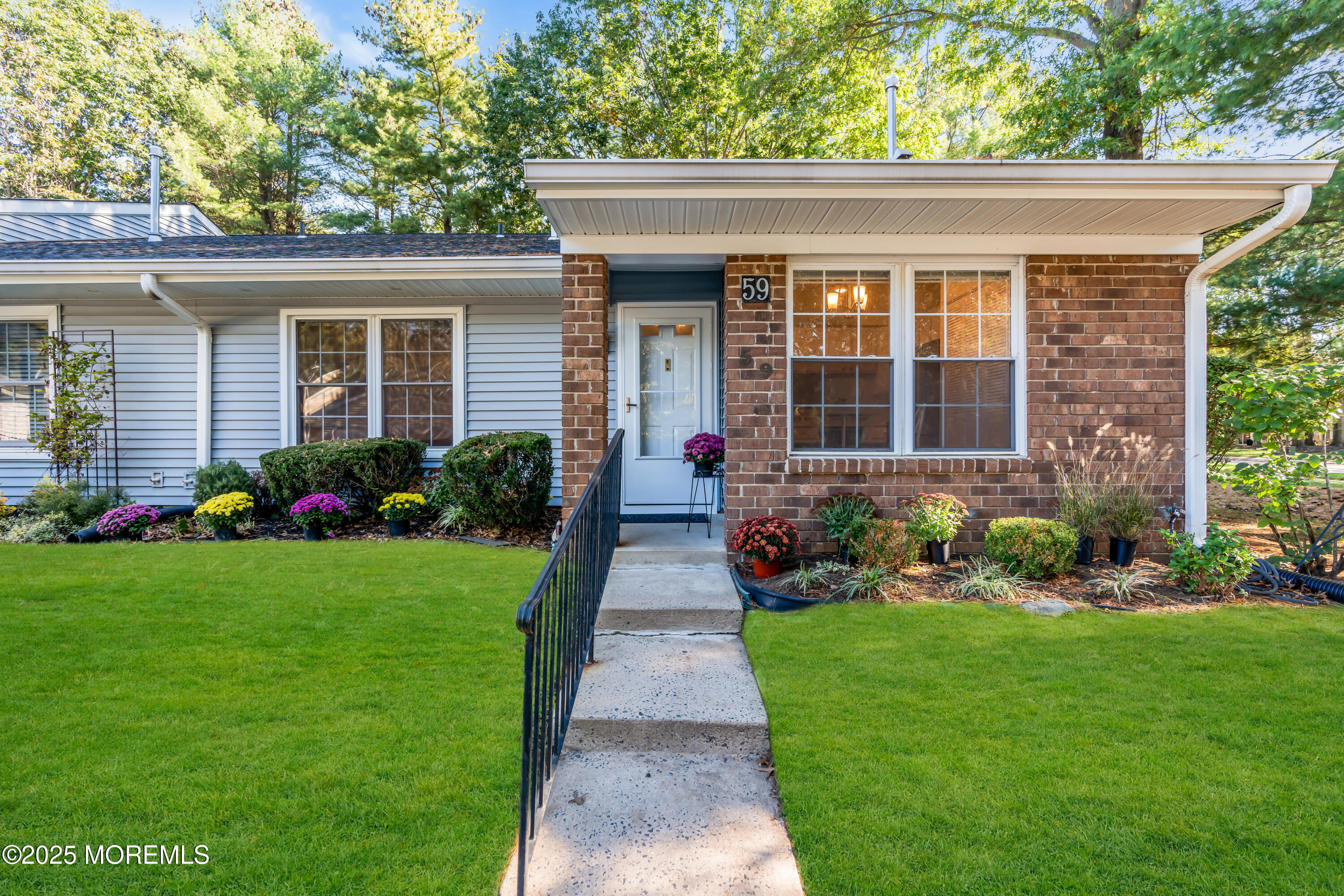 59 Boxwood Terrace Red Bank, NJ 07701 - Photo 1 of 46 a front view of a house with a garden and plants
