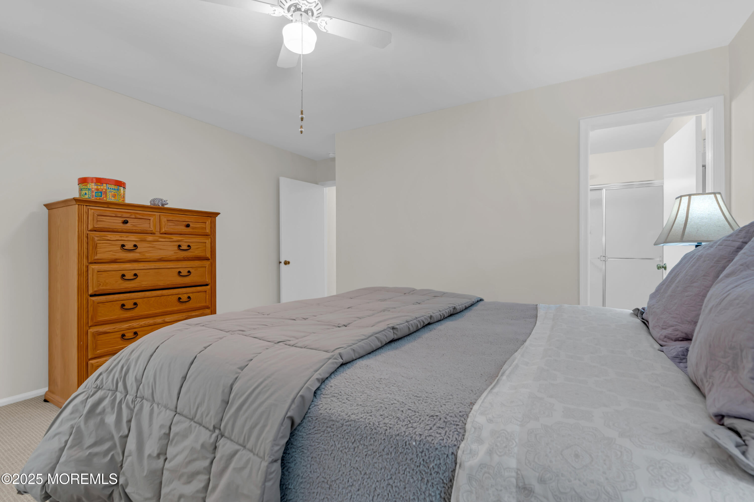 59 Boxwood Terrace Red Bank, NJ 07701 - Photo 30 of 46 a bedroom with a bed and a chandelier
