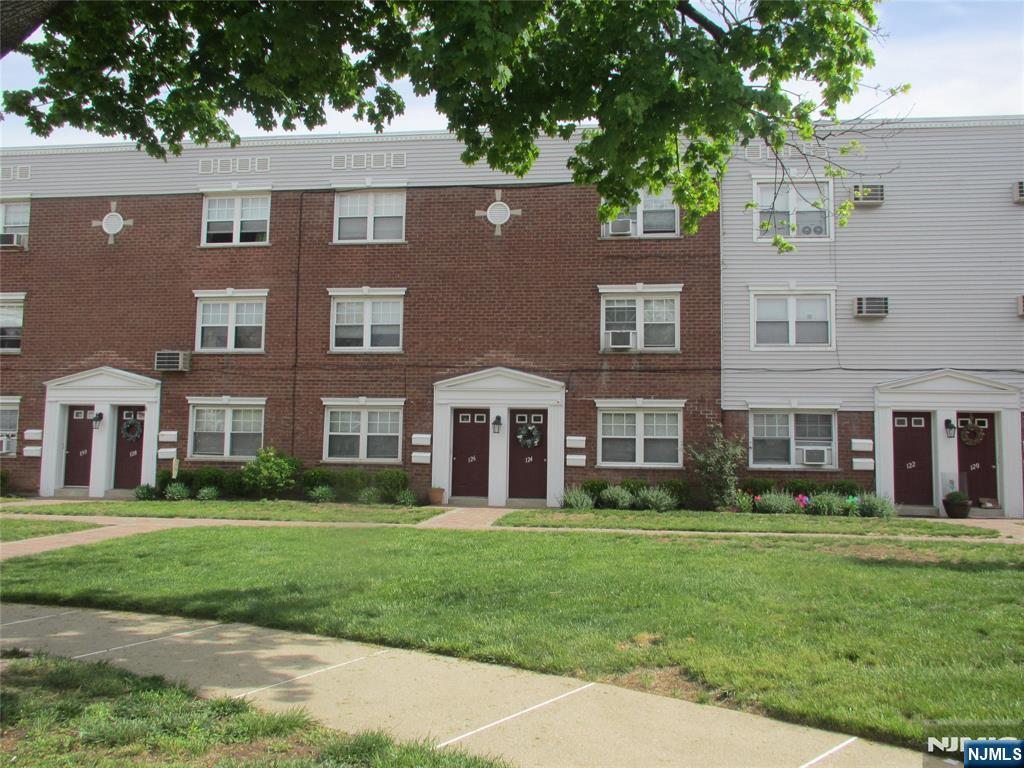 a front view of building with yard and green space