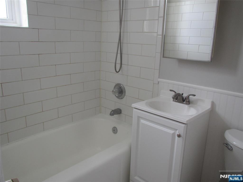 126 Hastings Avenue, Unit A Rutherford, NJ 07070 - Photo 9 of 11 a white bath tub sitting next to a white sink