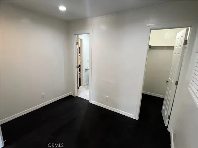 an empty room with wooden floor and a window