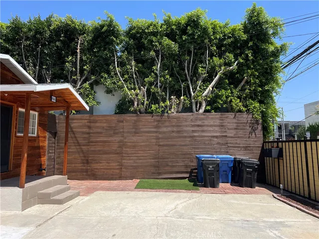 a wooden bench sitting in front of a building