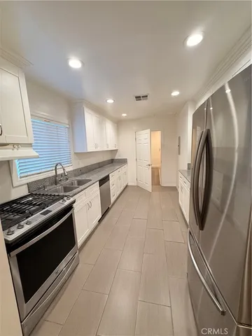 a kitchen with stainless steel appliances granite countertop a stove and a refrigerator