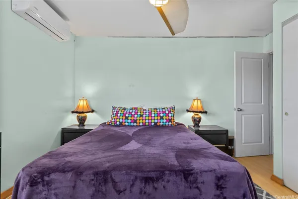 a bedroom with a bed and a painting on the wall