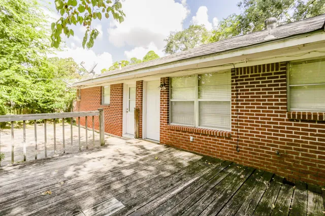 a view of a brick house with a large window