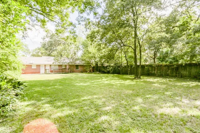 a backyard of a house with large trees