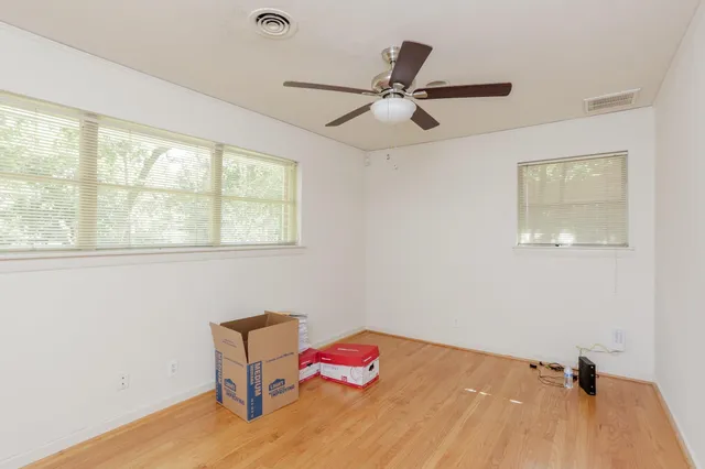 a bedroom with a bed and a large window