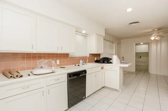 a kitchen with a sink cabinets and appliances