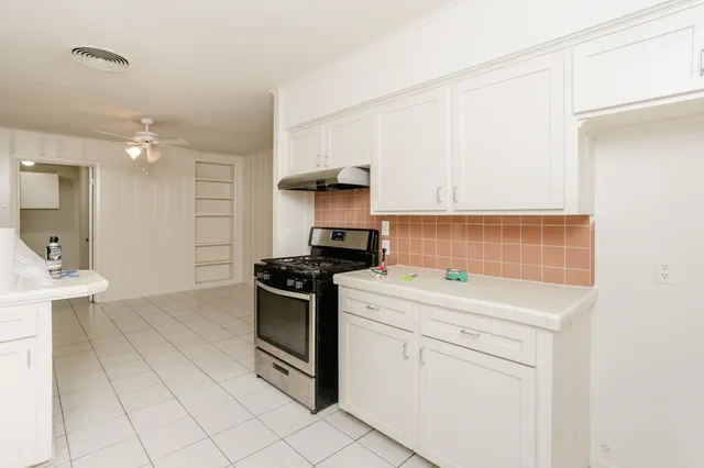 a kitchen with a stove and a sink