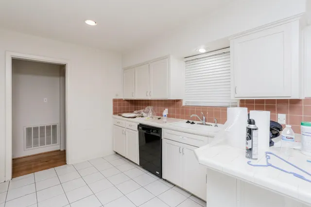 a kitchen with a sink cabinets and appliances