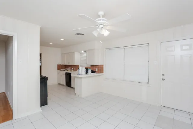a view of kitchen with center island and stainless steel appliances