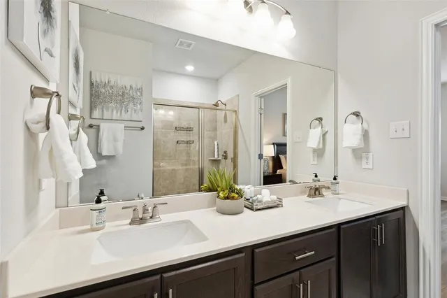 a bathroom with double sink and a mirror