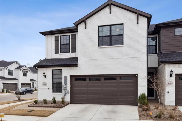 a front view of a house with garage