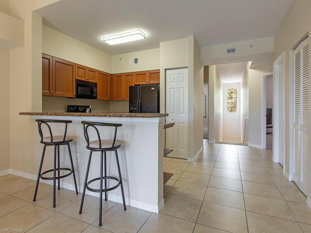 Undisclosed Address Estero, FL 33928 - Photo 4 of 14 a kitchen with stainless steel appliances a refrigerator and a stove top oven