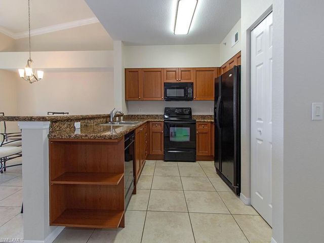 a kitchen with stainless steel appliances granite countertop a stove and a refrigerator