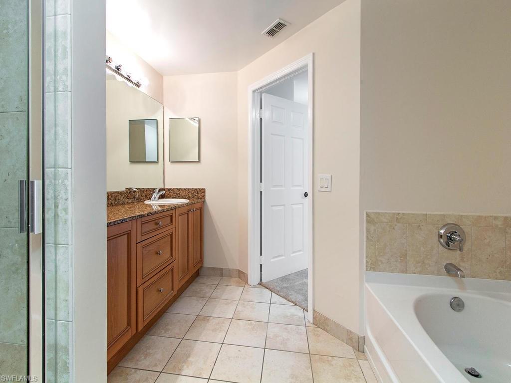 Undisclosed Address Estero, FL 33928 - Photo 7 of 14 a spacious bathroom with a tub sink and mirror
