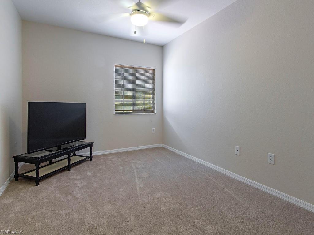 Undisclosed Address Estero, FL 33928 - Photo 8 of 14 an empty room with windows and flat screen tv