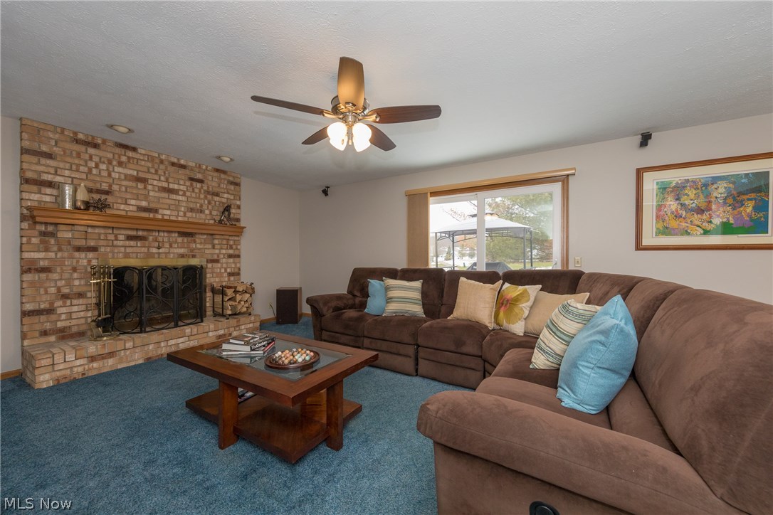 6150 Liberty Road Solon, OH 44139 - Photo 9 of 29 The family room highlights the large brick fireplace and boasts newer sliding doors that lead to a sizeable deck.