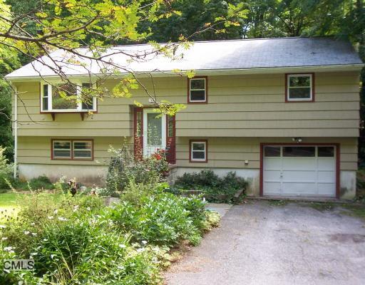 36 Rock Spring Lane Ridgefield, CT 06877 - Photo 1 of 1 a front view of a house with a yard