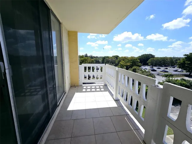 a view of a balcony with wooden floor