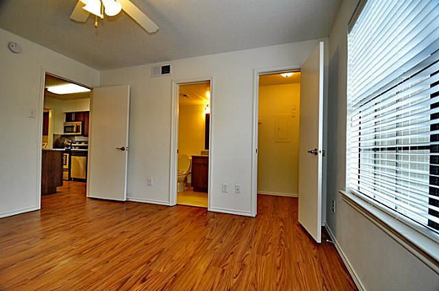 6910 Skillman Street, Unit 2039 Dallas, TX 75231 - Photo 2 of 24 wooden floor in an empty room with a window