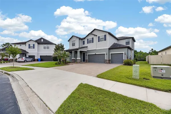 a front view of a house with a yard and garage