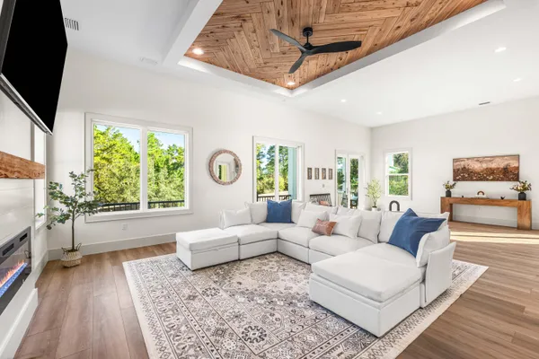 a living room with furniture and a wooden floor