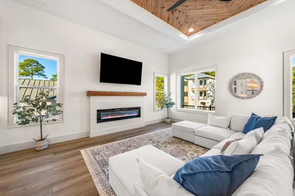 a living room with a fireplace and a rug