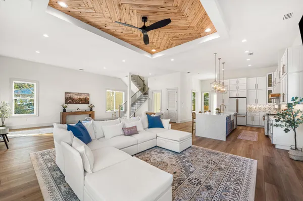 a kitchen with stainless steel appliances granite countertop a sink a stove and a wooden floors