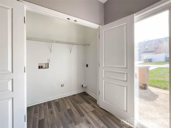 a view of walk in closet with empty racks