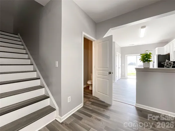 a view of a hallway with wooden floor and entryway