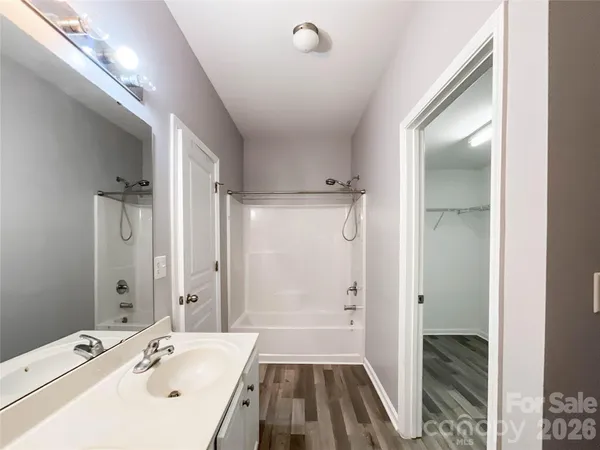 a spacious bathroom with a tub shower and sink