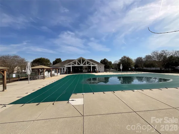 a view of house with garden space and car parked