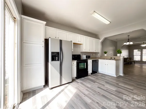 a kitchen with a refrigerator a sink and cabinets