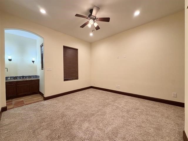 12410 Keith Road Beaumont, TX 77713 - Photo 33 of 45 an empty room with a chandelier fan and windows