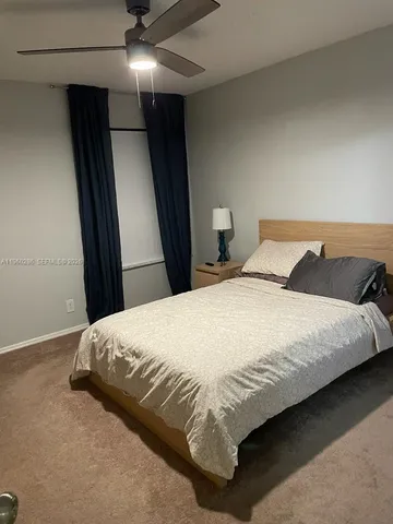 a bedroom with a bed and a mirror