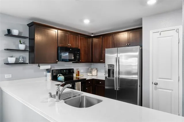 a kitchen with a refrigerator sink and microwave