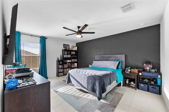 a living room with a bed furniture and a large window
