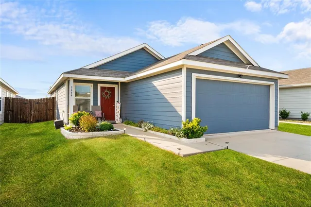 a front view of a house with yard and outdoor seating