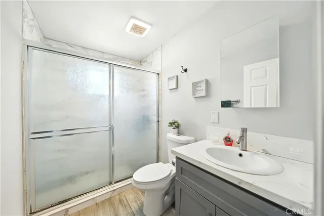 a bathroom with a sink toilet and shower