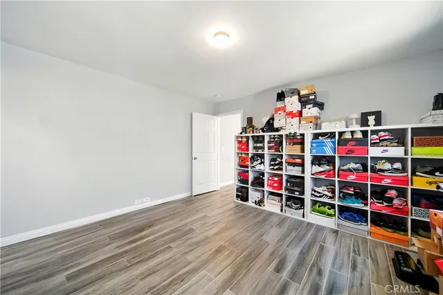 a view of empty room with toys and wooden floor