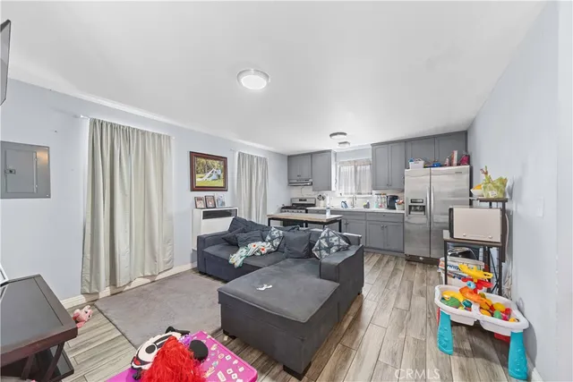 a living room with furniture and a wooden floor