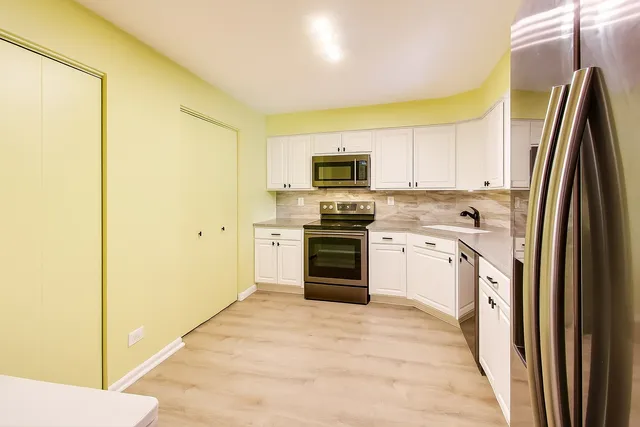 a bedroom with a bed and a large mirror