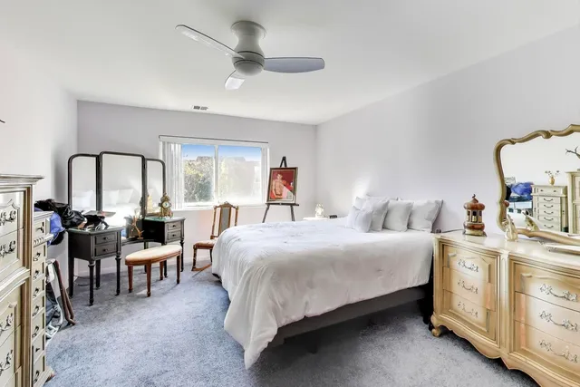 an empty room with a window and a ceiling fan