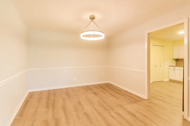 a view of a livingroom with wooden floor and furniture