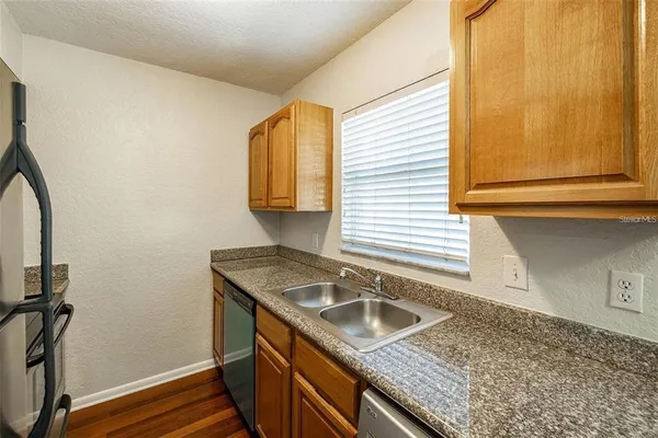 a kitchen with a sink a stove and cabinets