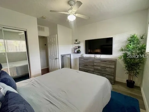 a bedroom with a bed and a flat screen tv