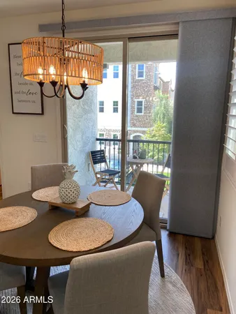 a dining room with furniture and a floor to ceiling window
